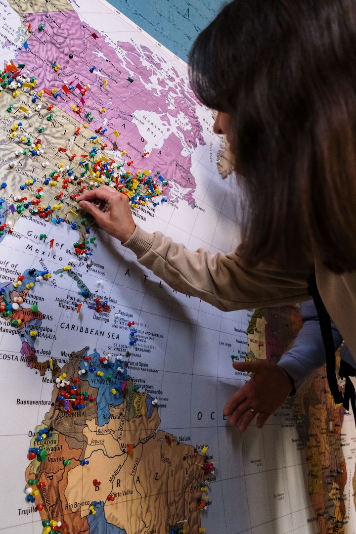 Operator marking booking locations on a world map